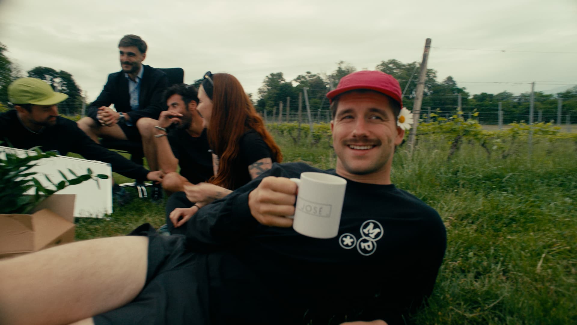 A PTO participant smiling with a mug in a vineyard after the race